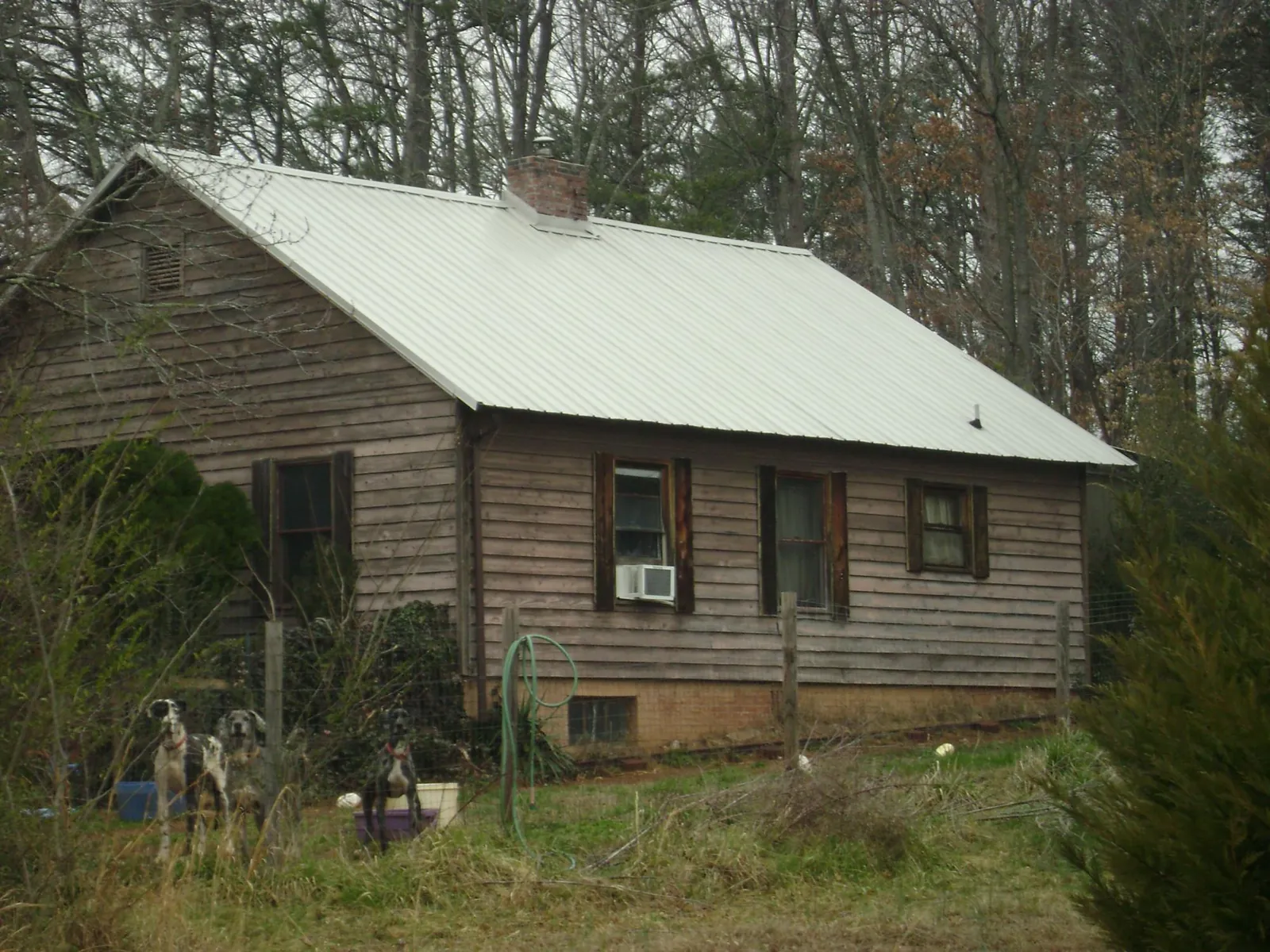 White metal roof on an old wood sided farmhouse, from a Metal Roof Installation job in Brewerton